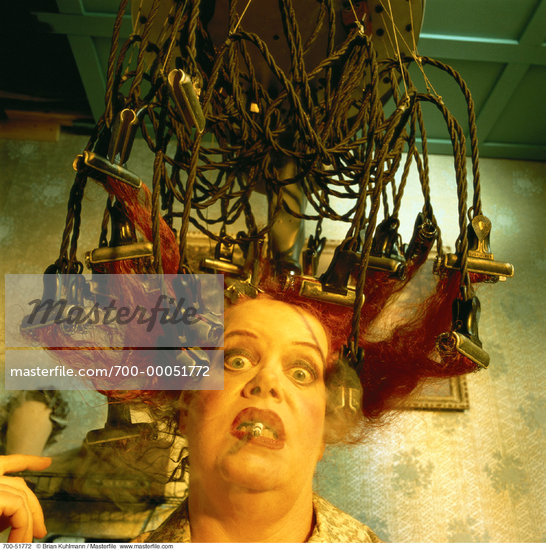 Mature Woman Using Vintage Hair Curlers Smoking Cigarette