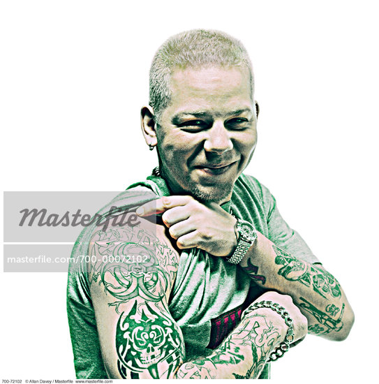 Portrait of Man Lifting Sleeve To Show Tattoo on Arm