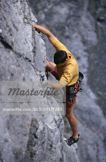 Man Climbing Cliff