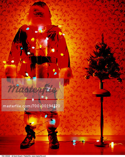 wrapped in christmas lights photography. Santa Claus Wrapped in Christmas Lights Stock Photo - Rights-Managed, 