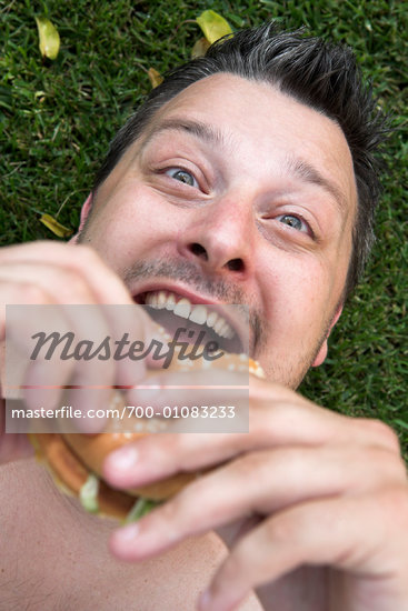 mouth eating hamburger