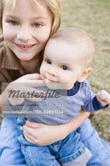 Boy Holding Baby