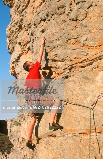 Man Climbing Cliff