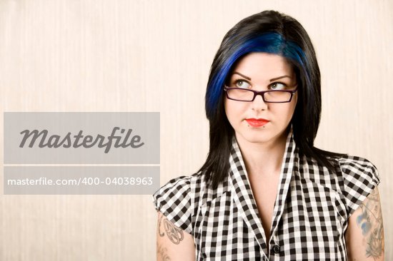Portrait of a cute rockabilly woman with tattoos on her arms