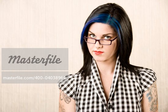 Portrait of a cute rockabilly woman with tattoos on her arms
