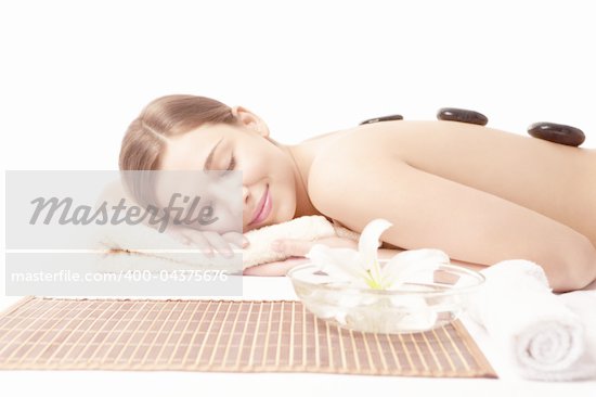 Young naked girl in a spa on a white background