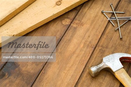 DIY hammer, nails and plank on table background Stock Photo - Royalty 