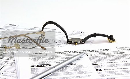 IRS Tax Extension form (4868) with pen, watch and glass Stock Photo -