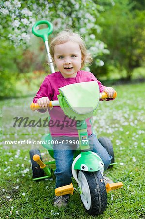  - 600-02990177em-Little-Girl-Riding-Three-Wheel-Bike