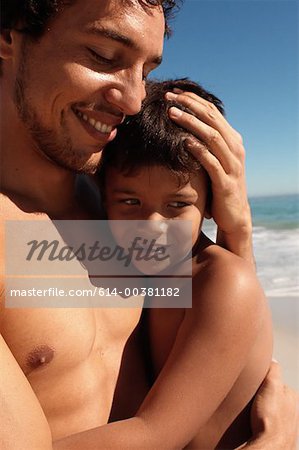614-00381182em-Father-hugging-son-on-a-beach.jpg