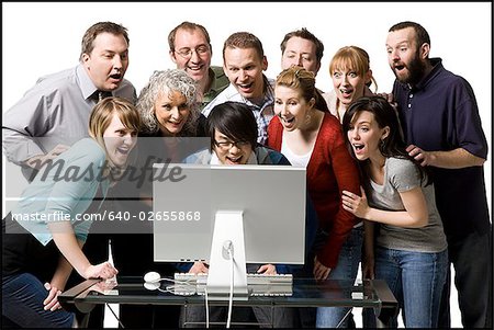 640-02655868em-people-crowded-around-a-computer-stock-photo.jpg