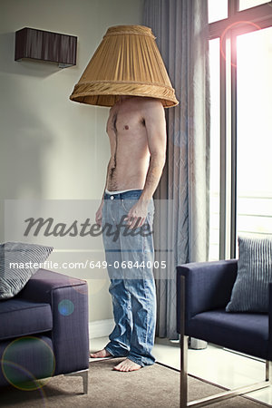 649-06844005em-Young-man-wearing-lampshade-on-head.jpg