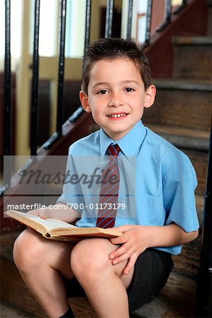  - 700-01173179em-Boy-Student-Reading-on-Steps---