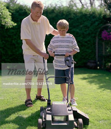  - 700-01234759em-Father-Teaching-Son-to-Mow-Lawn