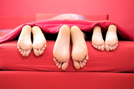 domestic life: threesome sharing the same bed Stock Photo - Budget Royalty-Free & Subscription, Code: 400-04008617