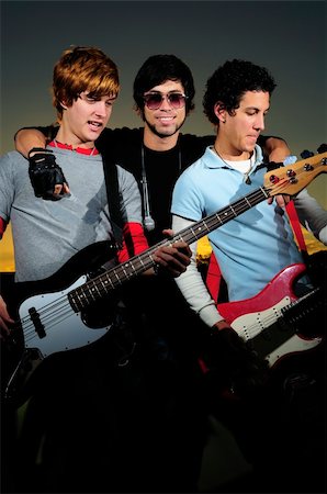 simsearch:400-04026083,k - Portrait of three young musicians with electric guitars Stock Photo - Budget Royalty-Free & Subscription, Code: 400-04009910