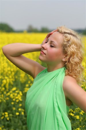simsearch:400-05027723,k - Beautiful young girl with field of nice yellow flowers Stock Photo - Budget Royalty-Free & Subscription, Code: 400-04009925
