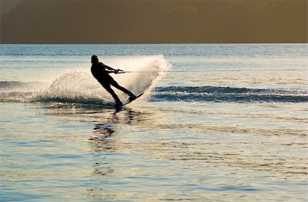 At sunset a Waterskier sprays water into air as he changes direction, on Pittwater, New South Wales, Australia Stock Photo - Budget Royalty-Free & Subscription, Code: 400-04001151