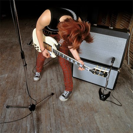 simsearch:400-04652753,k - Image of a female guitarist playing in front of an amplifier. Stock Photo - Budget Royalty-Free & Subscription, Code: 400-04003857
