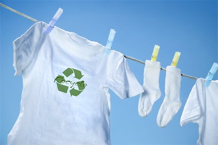pegged shirts drying - T-shirt with recycle logo drying on clothesline on a  summer day Stock Photo - Budget Royalty-Free & Subscription, Code: 400-04015648