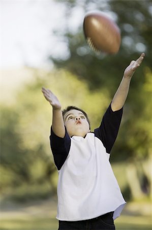 pigskin - Young boy with arms stretched out to catch a football Stock Photo - Budget Royalty-Free & Subscription, Code: 400-04015903