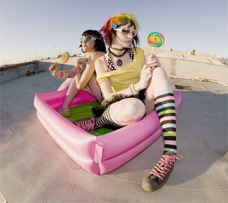 simsearch:400-04016564,k - Fisheye shot of girls in brightly colored clothing in a plastic pool on a roof with sunglasses and lollipops Stock Photo - Budget Royalty-Free & Subscription, Code: 400-04015919