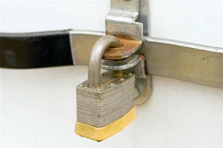 A padlock locking a door handle. Stock Photo - Budget Royalty-Free & Subscription, Code: 400-04016223