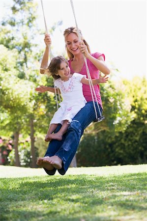 Mother and daughter having fun on garden swing Foto de stock - Super Valor sin royalties y Suscripción, Código: 400-04016909