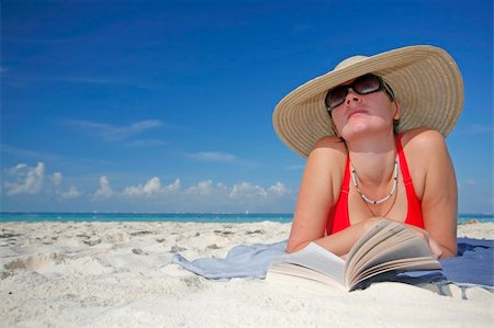 simsearch:400-03950469,k - One of a long series of photos taken on the Mexican Caribbean coast. Woman reading on the beach with a big hat Stock Photo - Budget Royalty-Free & Subscription, Code: 400-04017458
