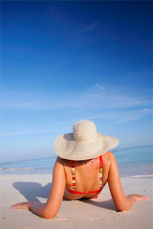 simsearch:400-03950469,k - One of a large series of photos taken on the Mexican Caribbean coast. A woman sunbathing on the shore with a dep blue sky. Stock Photo - Budget Royalty-Free & Subscription, Code: 400-04017450