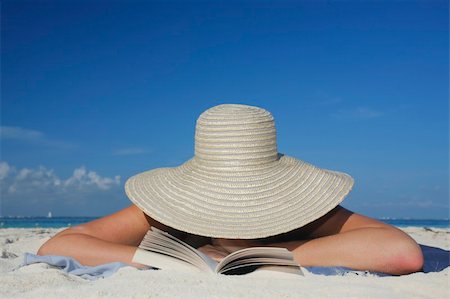 simsearch:400-03950469,k - One of a long series of photos taken on the Mexican Caribbean coast. Woman reading on the beach with a big hat Stock Photo - Budget Royalty-Free & Subscription, Code: 400-04017464