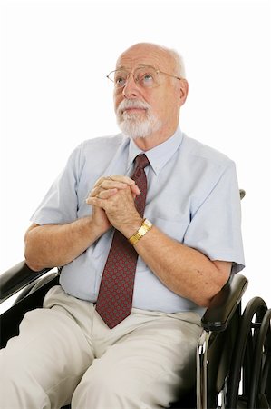 Senior man in a wheelchair with his hands folded in prayer.  Isolated on white. Stock Photo - Budget Royalty-Free & Subscription, Code: 400-04017508