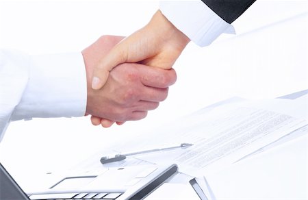 simsearch:400-04609965,k - view of handshake over paper and computer in the background Stock Photo - Budget Royalty-Free & Subscription, Code: 400-04018885