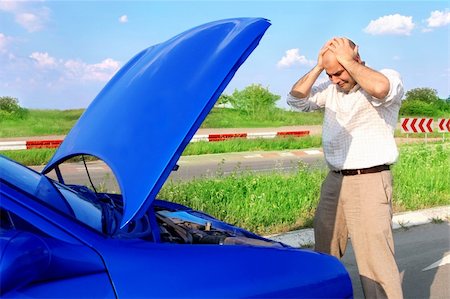 Dear me ! Businessman with his hands to his head and defected a car Stock Photo - Budget Royalty-Free & Subscription, Code: 400-04019433