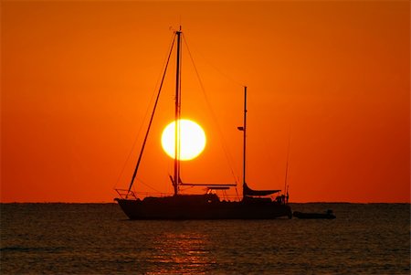 simsearch:400-04377093,k - Sailing boat silhouette and golden sunrise over the ocean Stock Photo - Budget Royalty-Free & Subscription, Code: 400-04010260