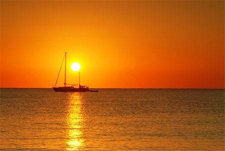 simsearch:400-05896461,k - Sailing boat silhouette and golden sunrise over the ocean Stock Photo - Budget Royalty-Free & Subscription, Code: 400-04010261