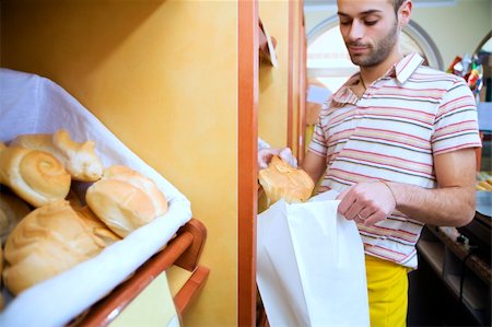 simsearch:400-04012842,k - sales clerk in a supermarket putting some bread in a bag Stock Photo - Budget Royalty-Free & Subscription, Code: 400-04013774
