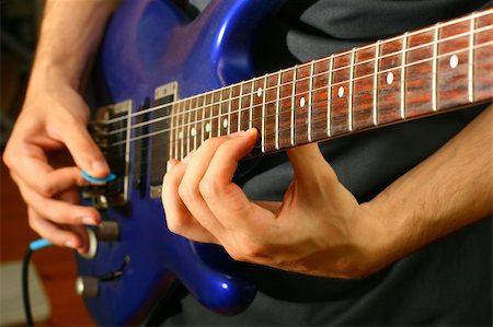 picture of the blue playing a instruments - man play solo on blue guitar Stock Photo - Budget Royalty-Free & Subscription, Code: 400-04024157