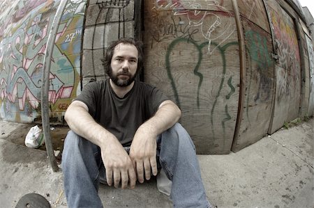 drifter - A homeless man on the city streets, filled with anxiety and hopelessness.  Shot with fish-eye lens and de-saturated. Stock Photo - Budget Royalty-Free & Subscription, Code: 400-04024802