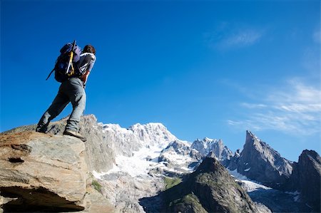 simsearch:400-05118687,k - Young male trekker looking at Mont Blanc south face; Mont Blanc, italian side, Courmayeur, Italy. Stock Photo - Budget Royalty-Free & Subscription, Code: 400-04025060