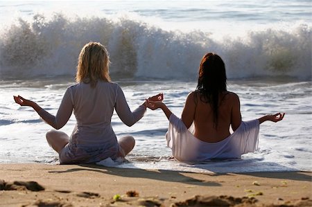 The blonde and brunette meditate on a beach Stock Photo - Budget Royalty-Free & Subscription, Code: 400-04025285