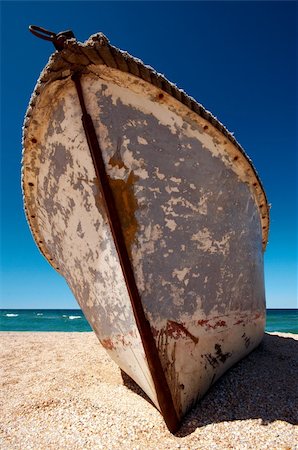 simsearch:400-04793526,k - Old lonely boat abandoned at seacoast on a background of the dark blue sky Stock Photo - Budget Royalty-Free & Subscription, Code: 400-04027791