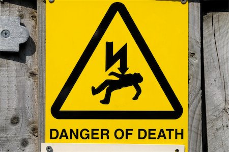 A bright high voltage electricity warning sign showing what happens if you trespass. Stock Photo - Budget Royalty-Free & Subscription, Code: 400-04029014