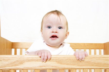 simsearch:400-05153083,k - Little Baby holding onto side of crib Stock Photo - Budget Royalty-Free & Subscription, Code: 400-04020157