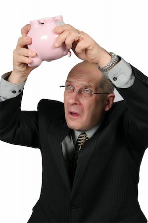 Business man holding Piggy Bank upside down in air - Where is the money gone Stock Photo - Budget Royalty-Free & Subscription, Code: 400-04020210