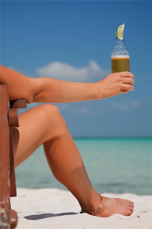 simsearch:6109-06004195,k - Woman sitting in a deckchair drinking beer Stock Photo - Budget Royalty-Free & Subscription, Code: 400-04020327