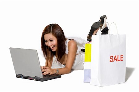 simsearch:400-04559945,k - young woman happy shopping online on a laptop with shopping by her side with angel wings Photographie de stock - Aubaine LD & Abonnement, Code: 400-04022510