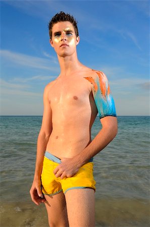 simsearch:400-03944633,k - Portrait of young male model enjoying the beach with artistic bodypaint drawing on the arm Stock Photo - Budget Royalty-Free & Subscription, Code: 400-04022771