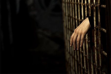 Human hand through a prison cell in the conclusion Stock Photo - Budget Royalty-Free & Subscription, Code: 400-04023505