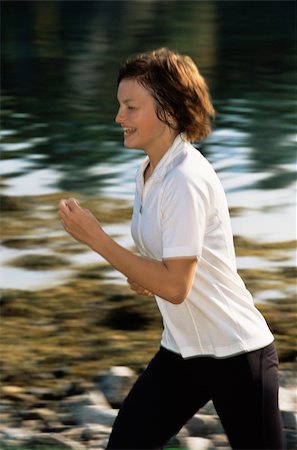 simsearch:400-04535435,k - Young woman running along water's edge Stock Photo - Budget Royalty-Free & Subscription, Code: 400-04034952